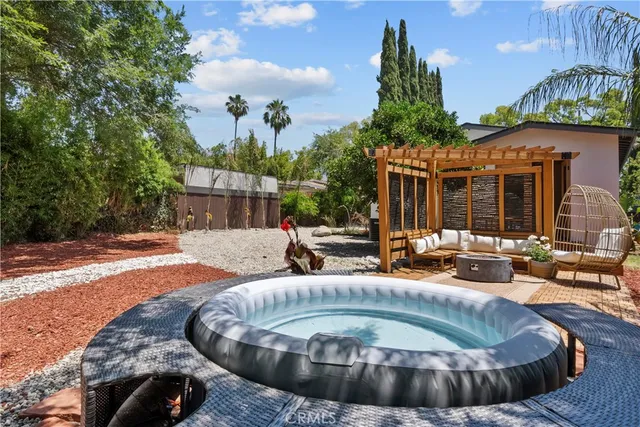 a view of a house with swimming pool and sitting area