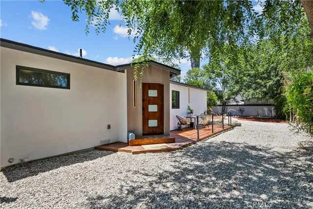 a backyard of a house with barbeque oven