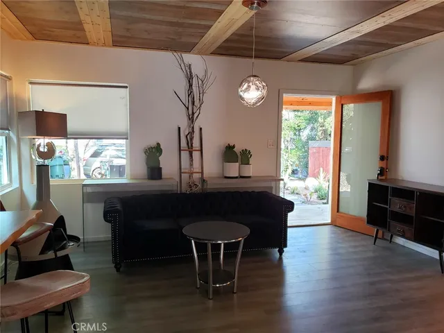 a dining room with furniture and wooden floor