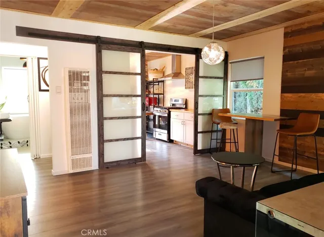 a view of a livingroom with furniture window and wooden floor