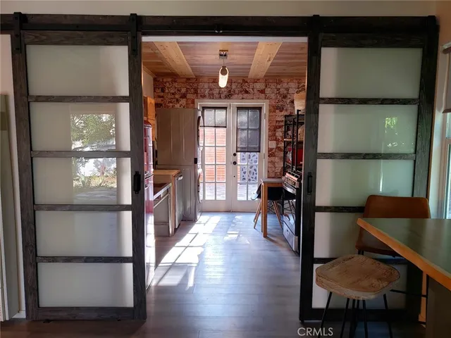 a view of hallway with furniture and a window