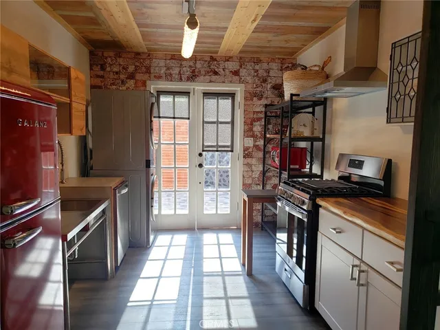 a kitchen with stainless steel appliances granite countertop a stove and a refrigerator