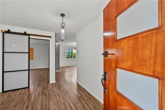 a view of hallway with stairs and wooden floor