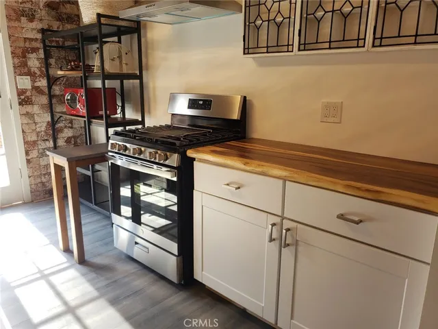 a kitchen with white cabinets and appliances