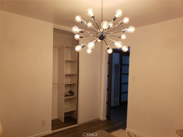 a view of a chandelier fan and entryway