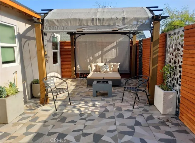 a outdoor view of a house with outdoor seating