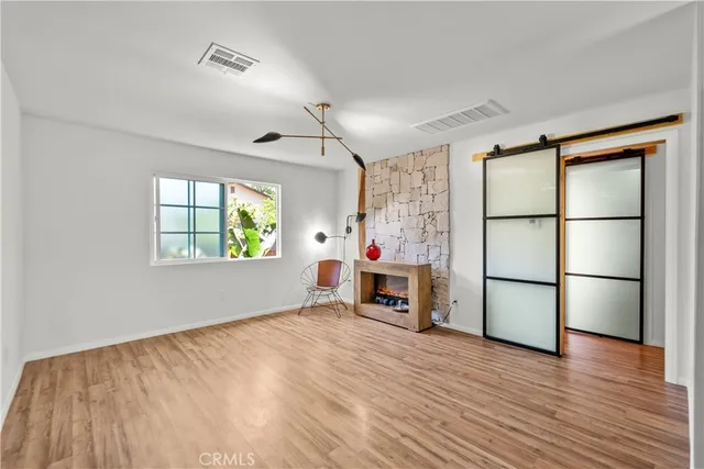 wooden floor in an empty room with a window
