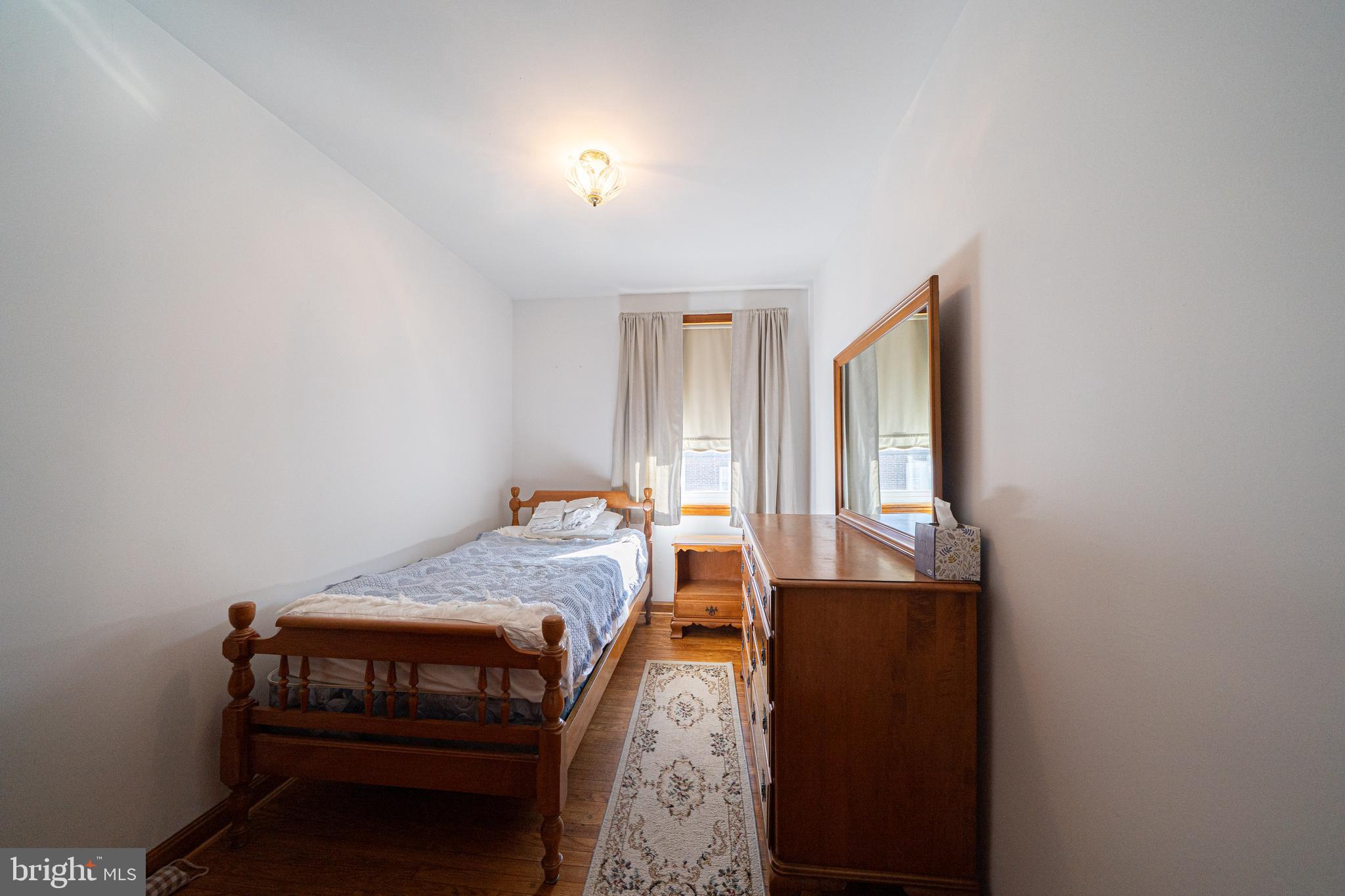 7409 Shisler Street Philadelphia, PA 19111 - Photo 16 of 27 a bedroom with a bed and a dresser next to it