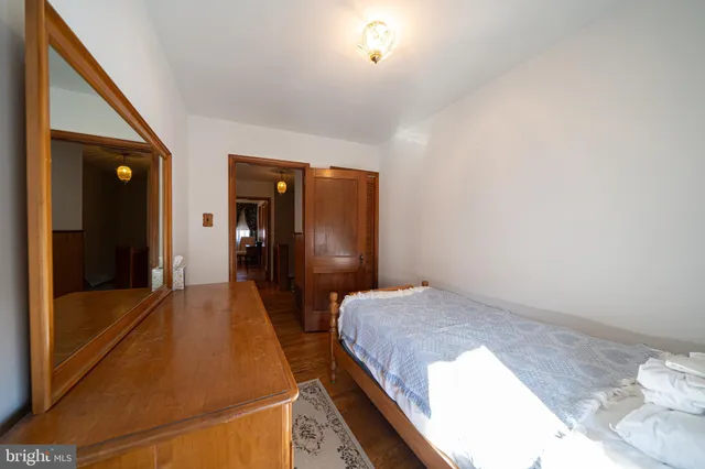 a bedroom with a bed and glass door