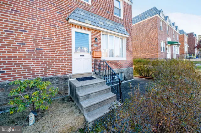 a view of a patio with plants and chairs