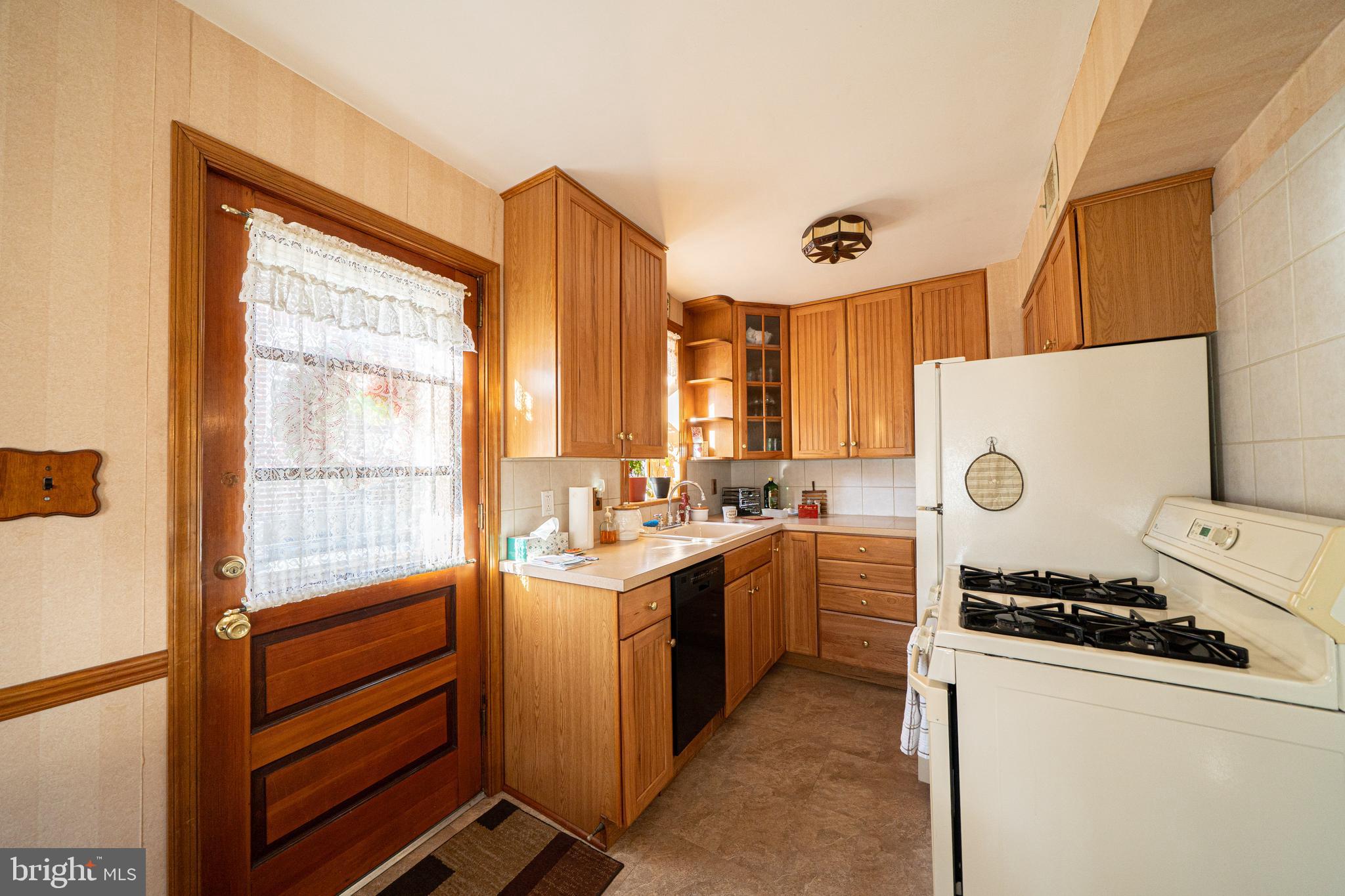 7409 Shisler Street Philadelphia, PA 19111 - Photo 10 of 27 a kitchen that has a sink and a stove in it