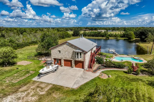 a view of house with swimming pool and lake view