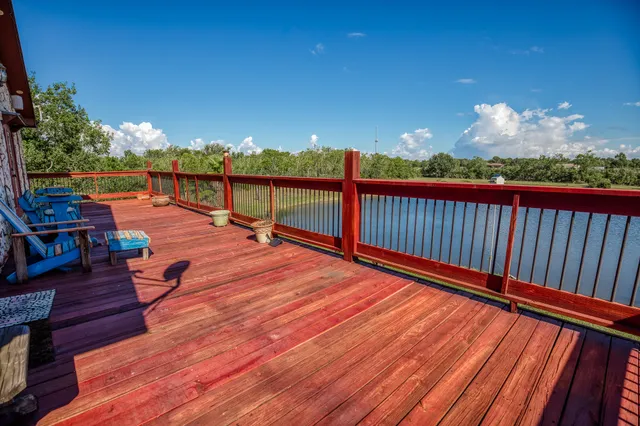 a balcony with chairs and wooden floor