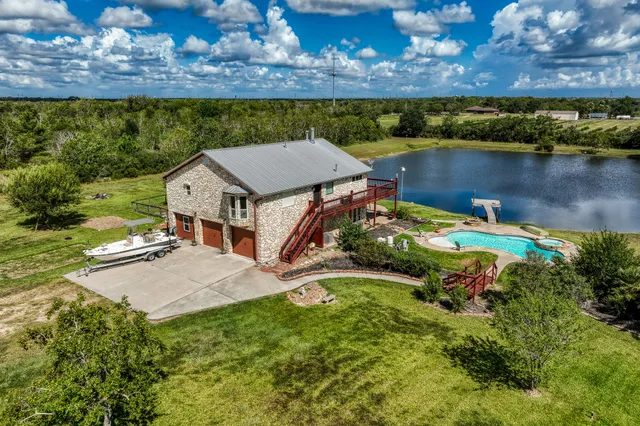 an aerial view of a house with a lake view