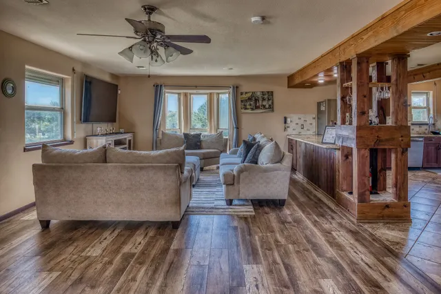 a living room with furniture and a wooden floor