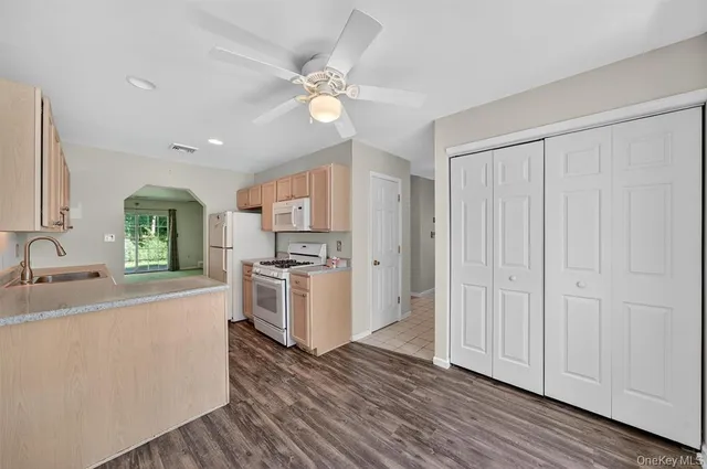 a kitchen with a refrigerator and a sink