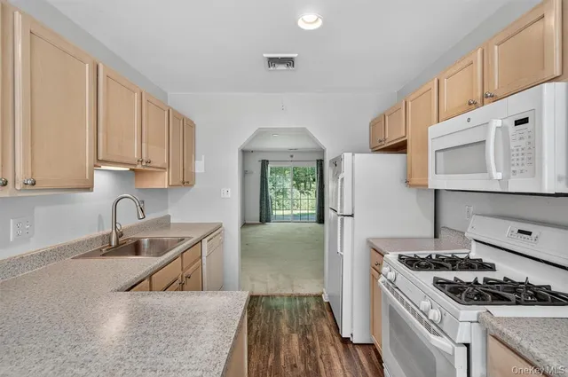 a kitchen that has a sink and a stove