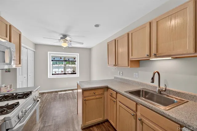 a kitchen with stainless steel appliances granite countertop a sink stove and cabinets