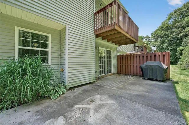 a view of a house with porch and potted plants