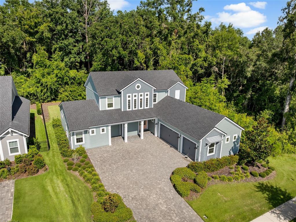 an aerial view of a house with a yard