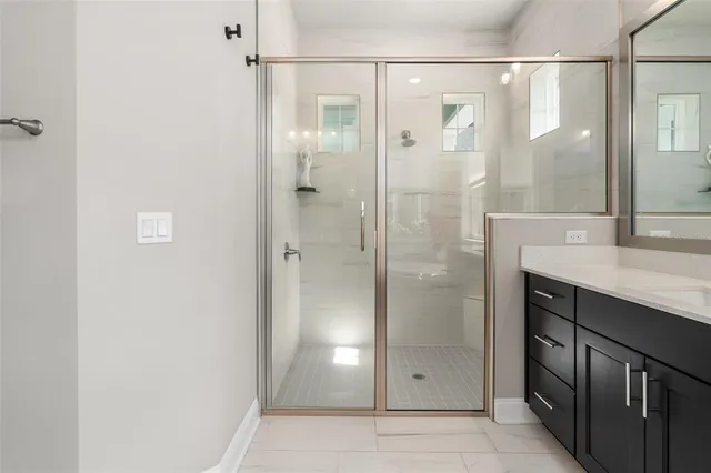 a bathroom with a sink vanity mirror and toilet