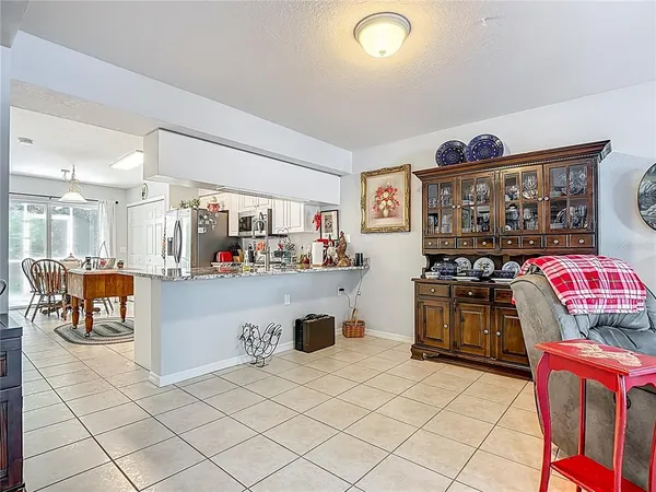 a living room with furniture and kitchen view