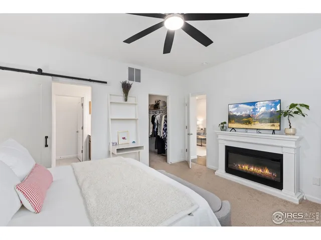 a bedroom with a bed and a fireplace