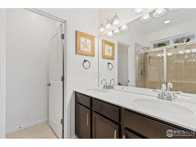 a bathroom with a sink vanity granite shower and a mirror