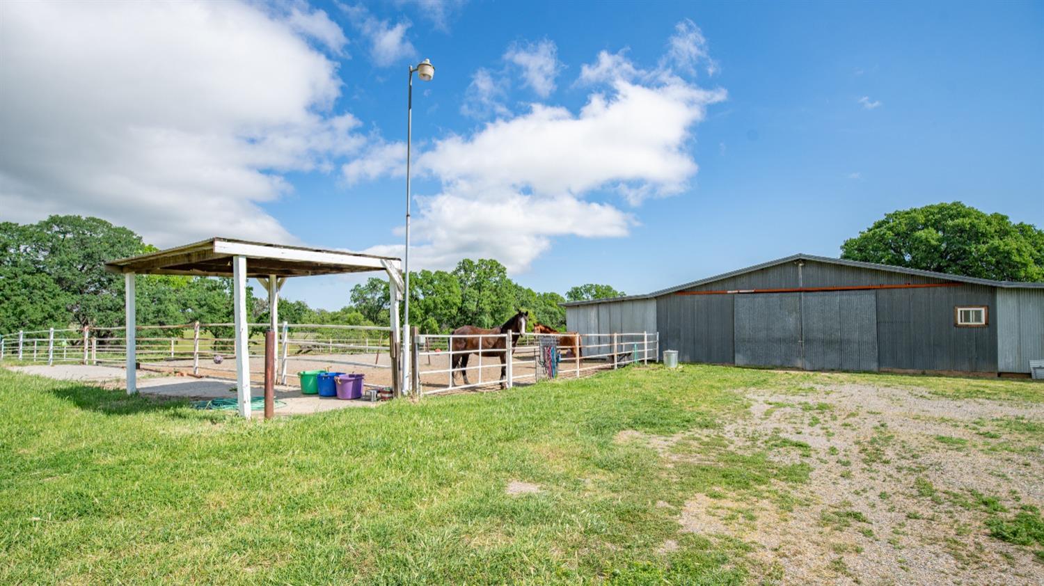 30247 Pleasant View Road Winters, CA 95694 - Photo 37 of 54 a view of a backyard with table and chairs under an umbrella