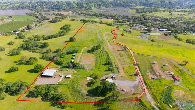 an aerial view of a house with garden space and street view