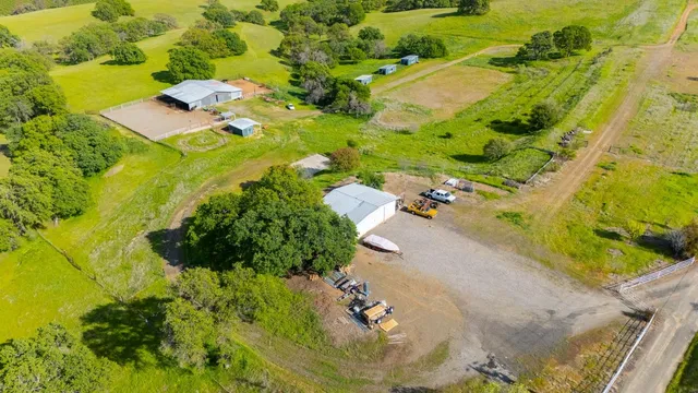 a view of a lush green hillside and houses