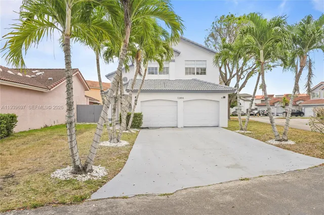 a front view of a house with white fence