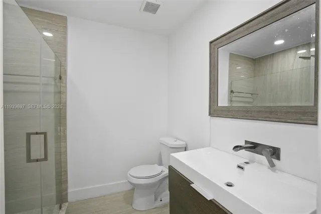 a spacious bathroom with a sink a toilet and shower
