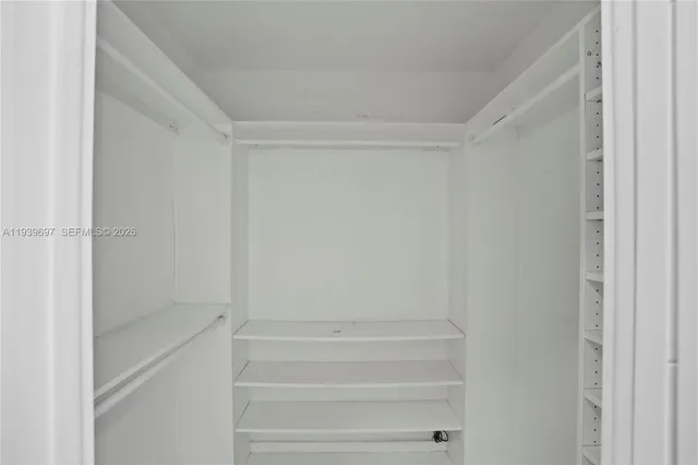 a view of a house with backyard and trees