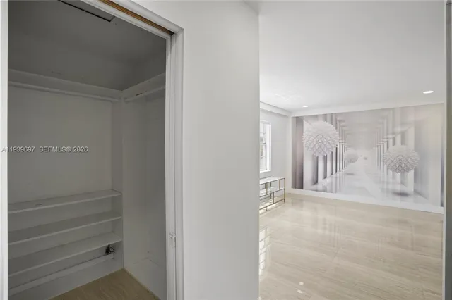 a view of a house with a yard and palm trees