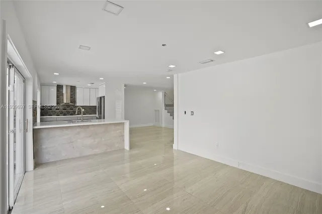 a kitchen with stainless steel appliances a refrigerator sink and microwave
