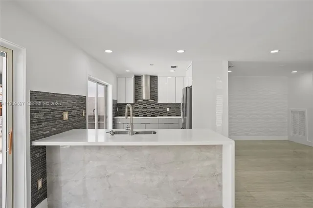 a kitchen with a sink and chandelier