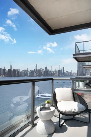 a view of a chair and tables in the balcony