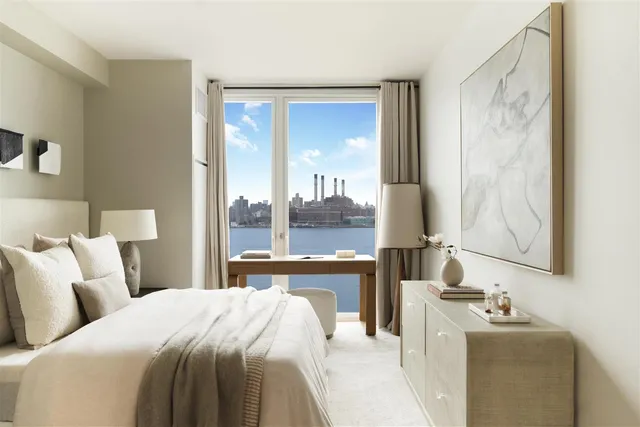 a bedroom with a bed and large windows