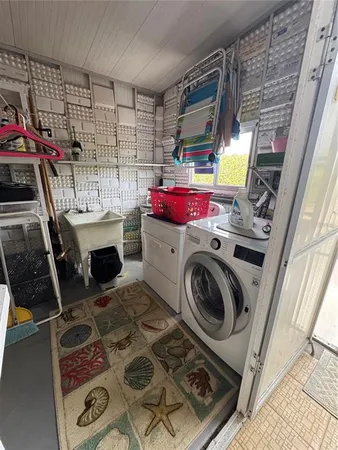 a kitchen with stainless steel appliances a stove a sink and white cabinets