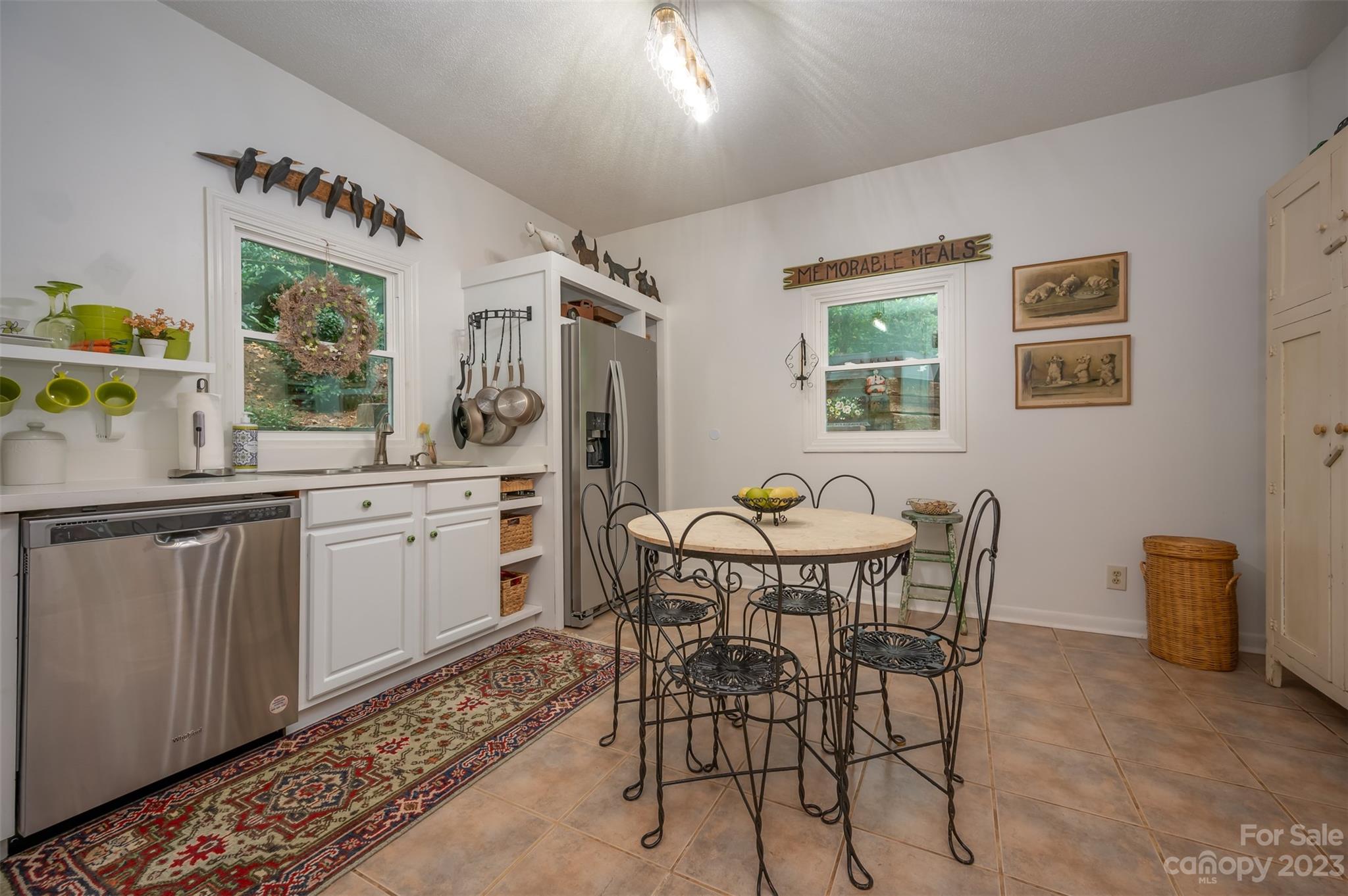196 Screven Road Tryon, NC 28782 - Photo 15 of 31 a kitchen with a table chairs and microwave