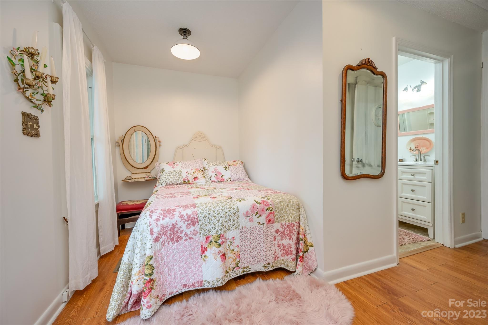 196 Screven Road Tryon, NC 28782 - Photo 19 of 31 a bedroom with a bed and a mirror