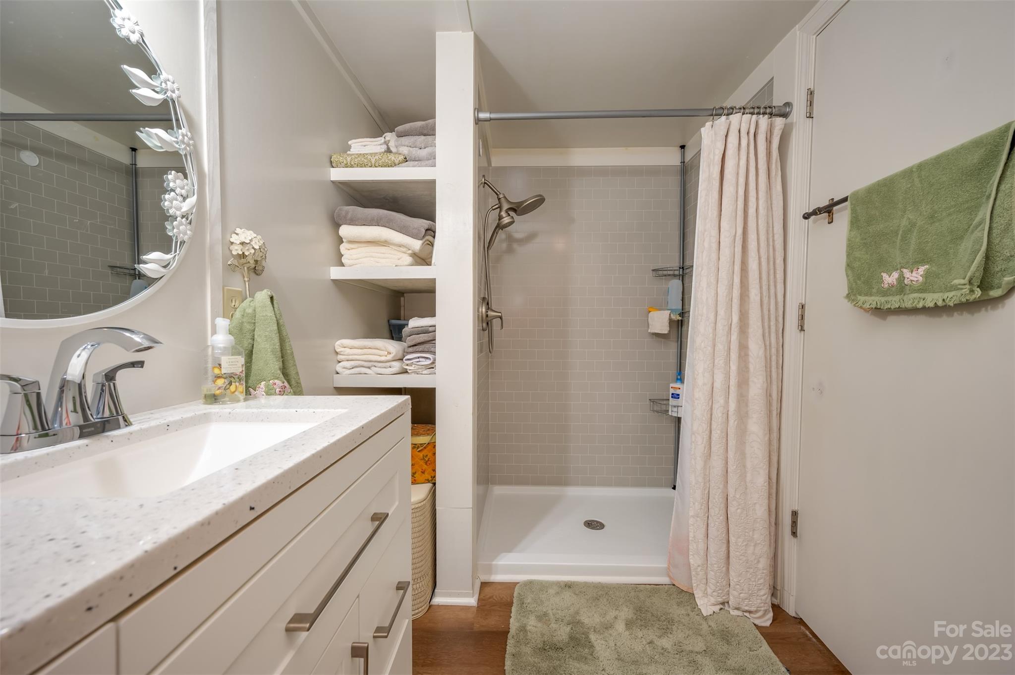 196 Screven Road Tryon, NC 28782 - Photo 23 of 31 a bathroom with a granite countertop sink mirror and shower