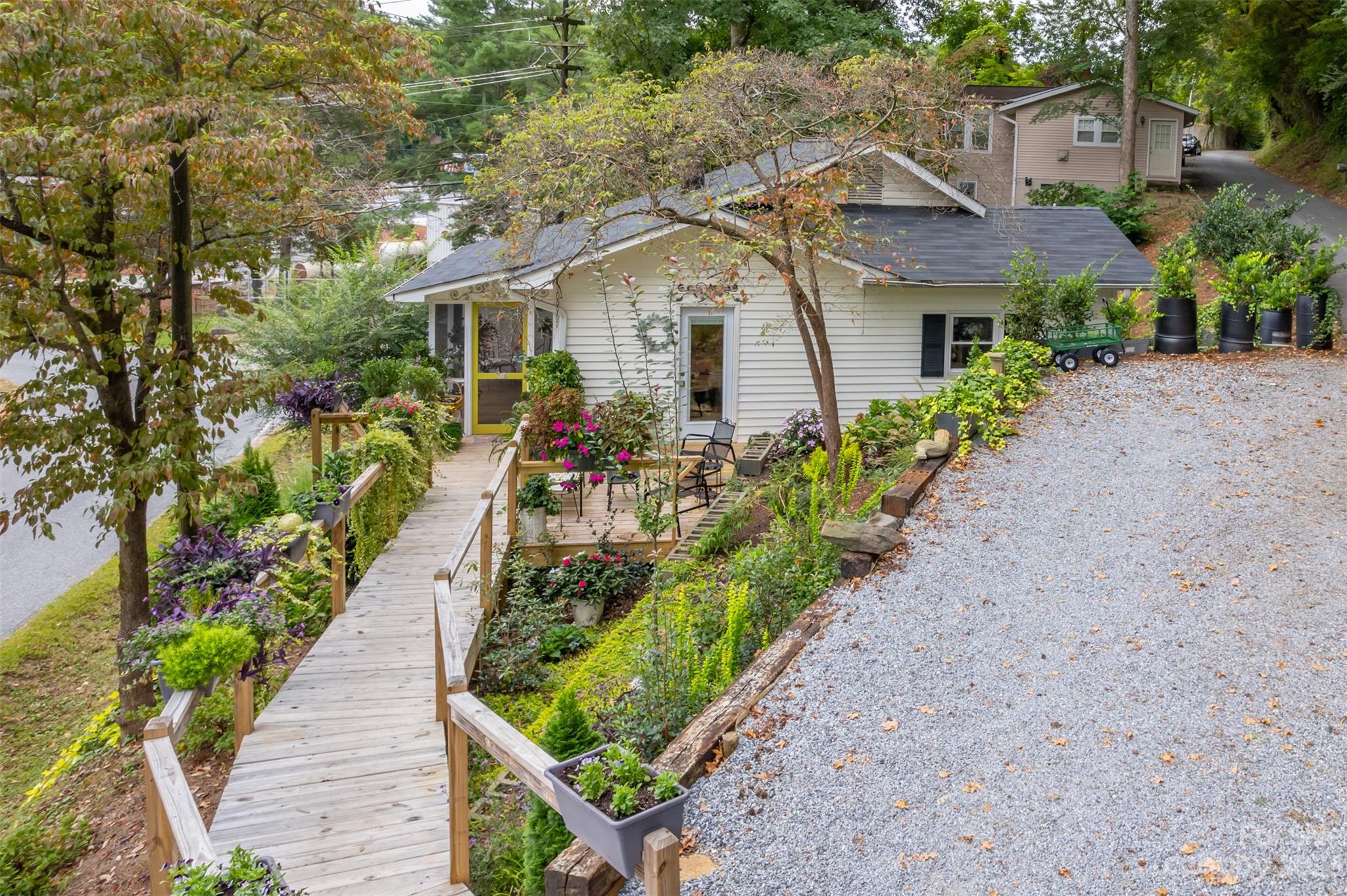196 Screven Road Tryon, NC 28782 - Photo 3 of 31 a aerial view of a house with a yard and potted plants