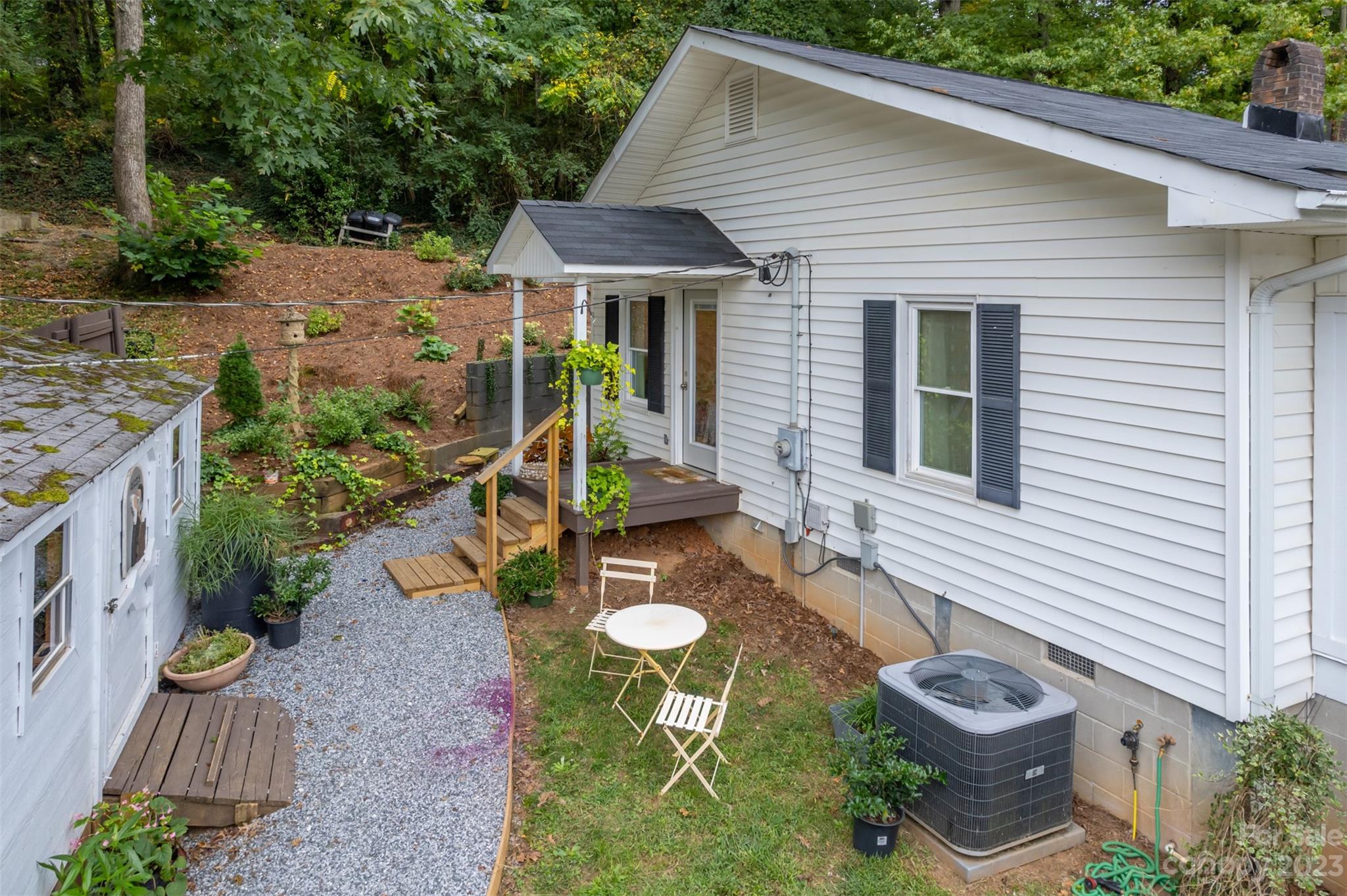 196 Screven Road Tryon, NC 28782 - Photo 31 of 31 a view of a backyard with table and chairs and potted plants