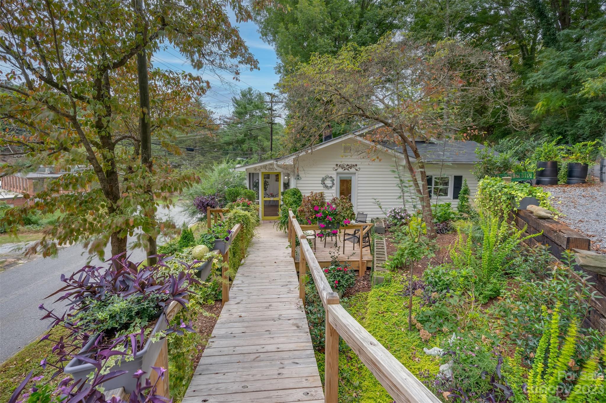 196 Screven Road Tryon, NC 28782 - Photo 4 of 31 a front view of a house with a yard and potted plants