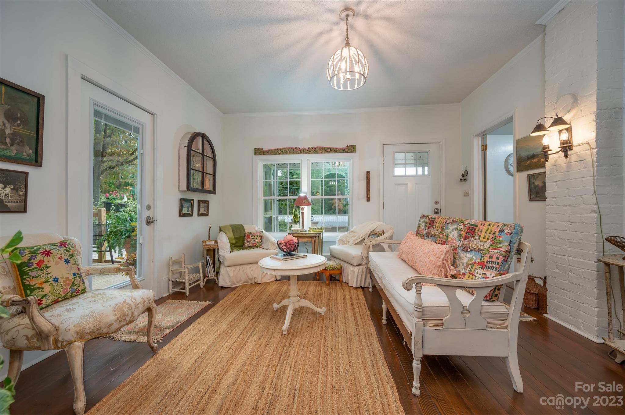 196 Screven Road Tryon, NC 28782 - Photo 10 of 31 a living room with furniture and a chandelier