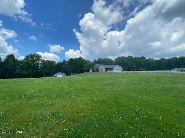 63 Callapoose Road Moscow, PA 18444 - Photo 3 of 73 a view of a golf course with a lake