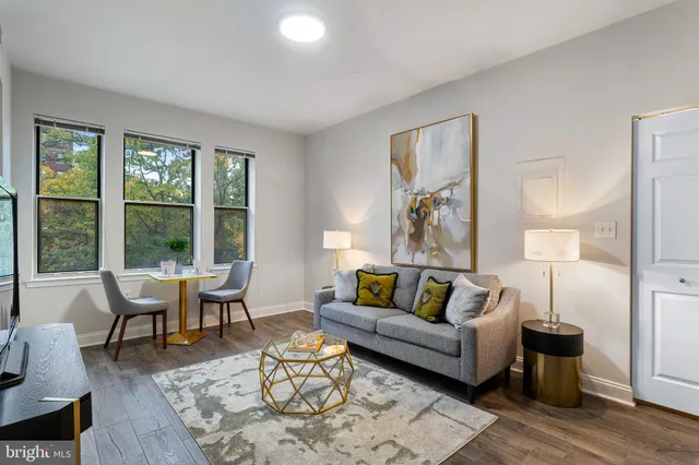 a living room with furniture and a large window