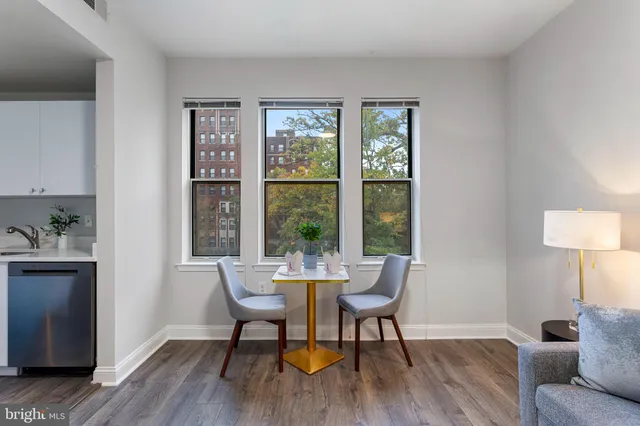 a dining room with furniture and wooden floor